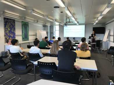 People in a seminar room listening to a presenter